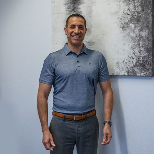 Smiling man in gray polo shirt