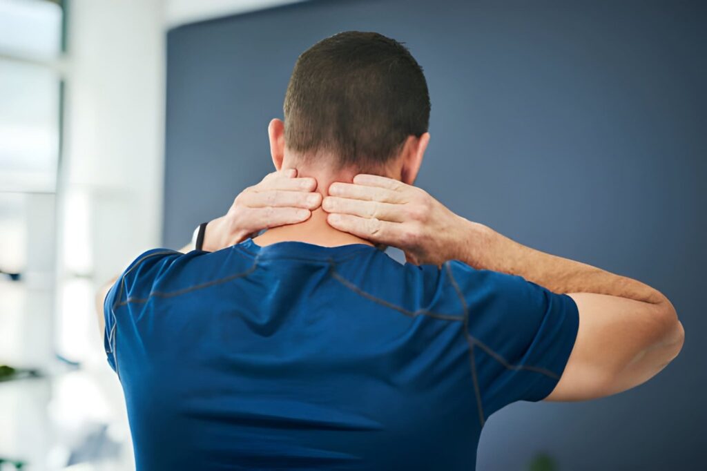 Person holding neck in pain