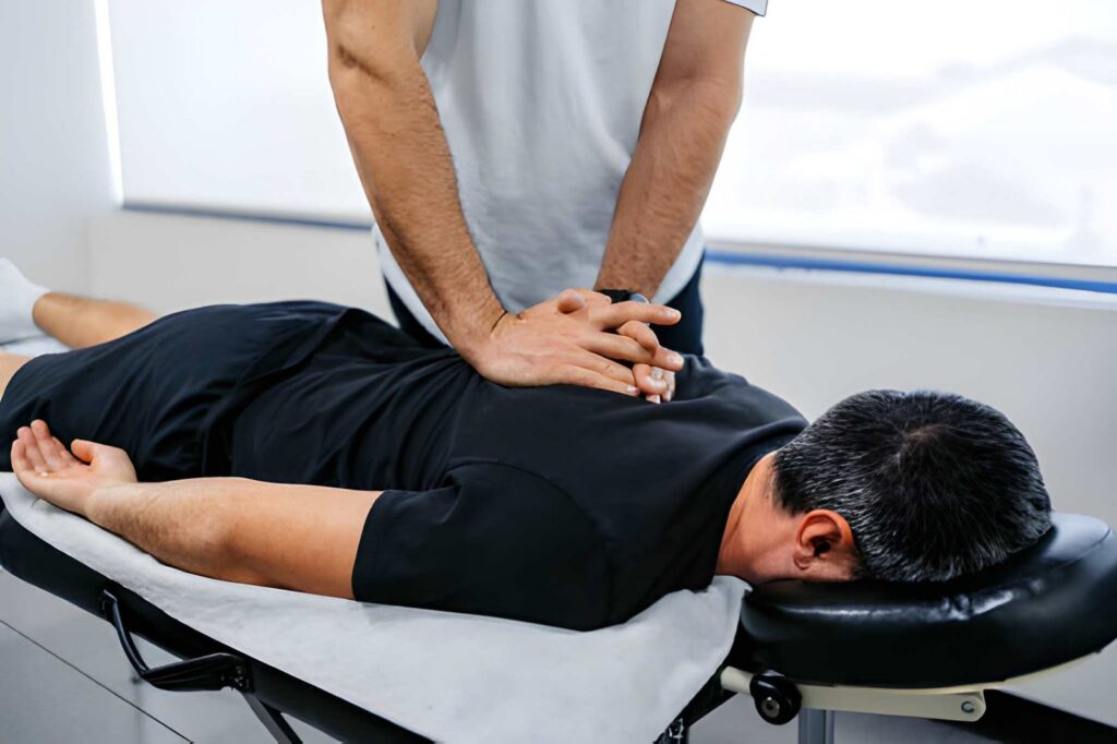 Patient receiving chiropractic back adjustment